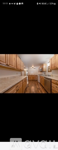 A kitchen with wooden cabinets and a central island.