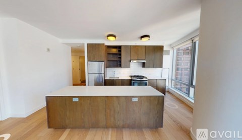 A kitchen with a wooden island in the middle of the room.