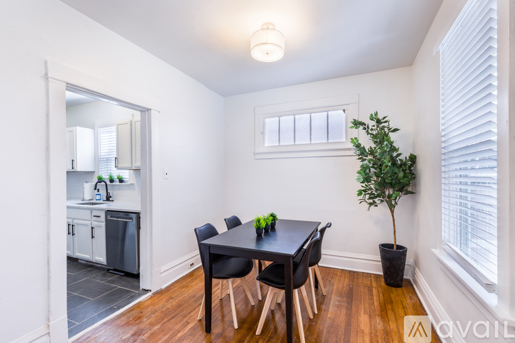 A dining room with a table and chairs.