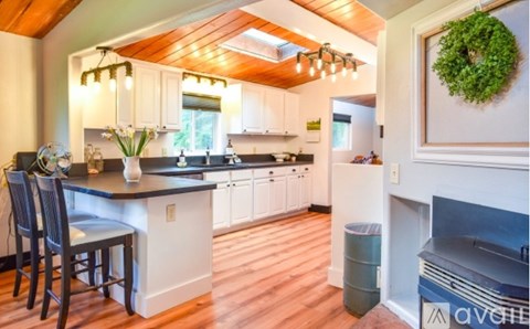 A kitchen with a dining table and chairs.