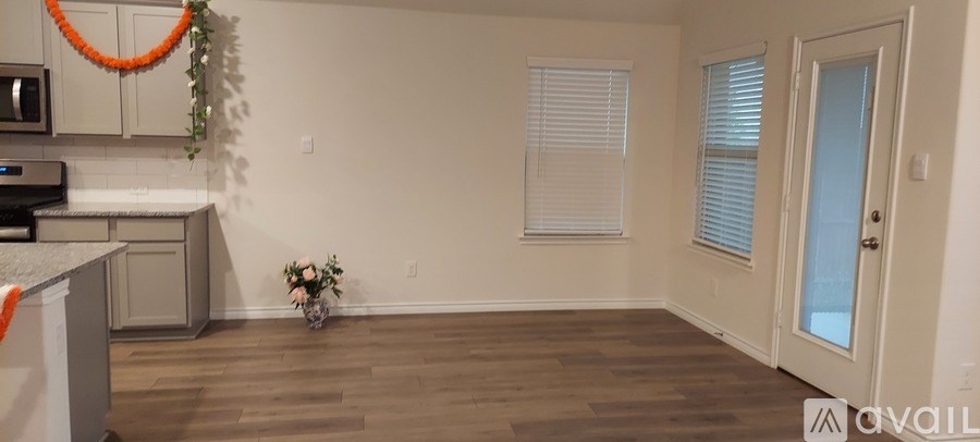 A kitchen with a counter and a fridge.