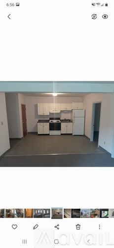 A kitchen with white cabinets and a stove top oven.