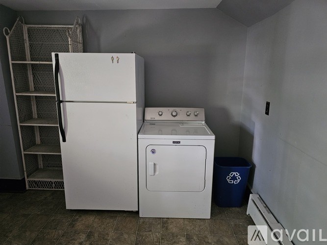 A white fridge and a white washing machine in a small room.