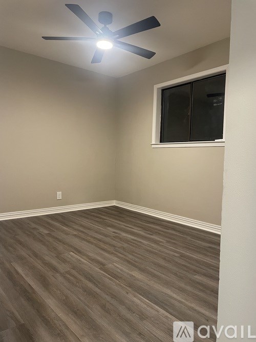 A room with a ceiling fan and a window.