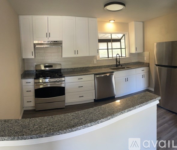 A room with a ceiling fan and a window.