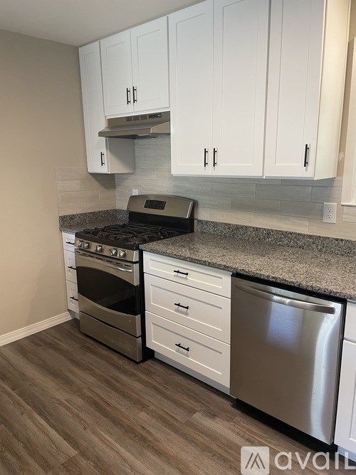 A room with a window and wooden flooring.