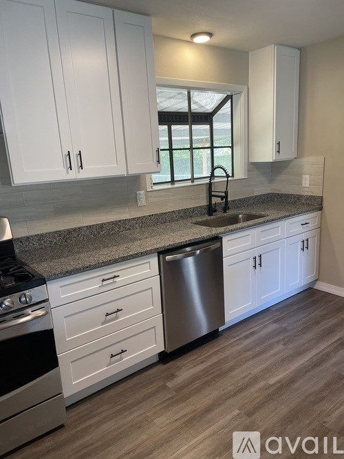 A hallway with a white door and a grey carpet.