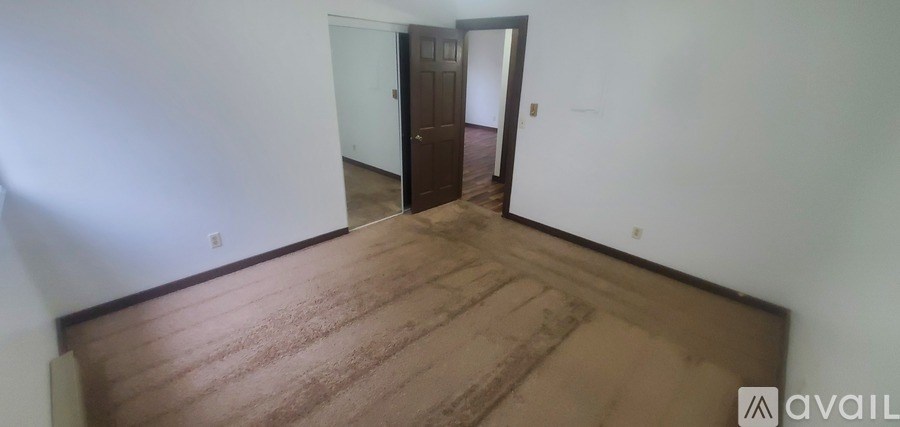 A room with a wooden floor and a door.