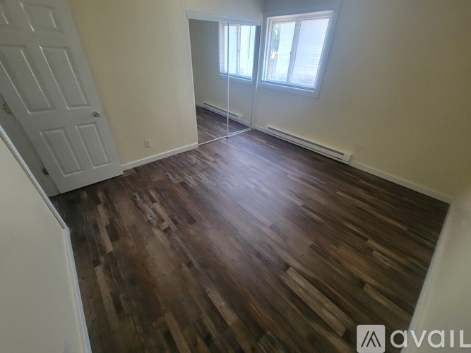 A bathroom with a toilet, sink, and mirror.