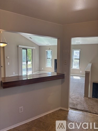 A room with a large mirror on the wall and a wooden frame.