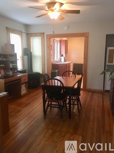 A room with wooden floors and a ceiling fan.