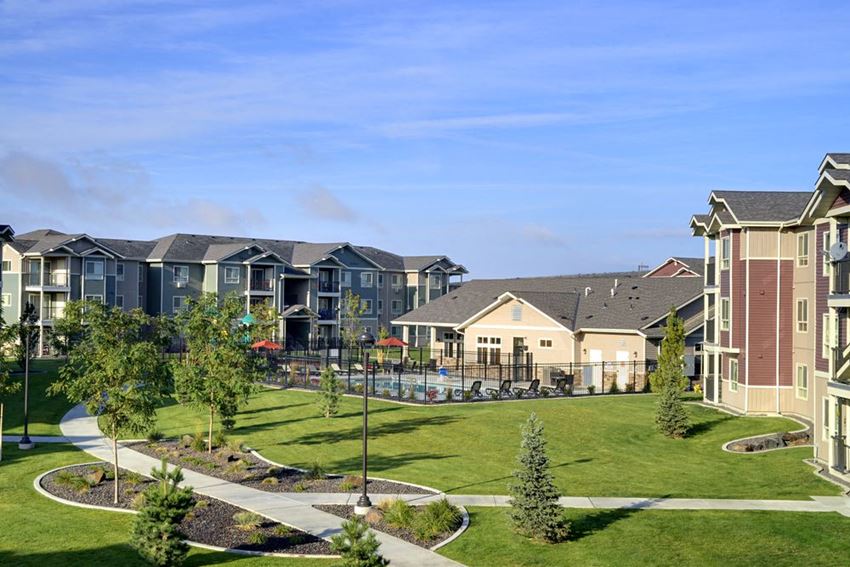 Copper Creek Apartments | Community Grounds Pathway with grass to apt buildings Colorado Springs, CO 80916 | Copper Creek Apts For Rent