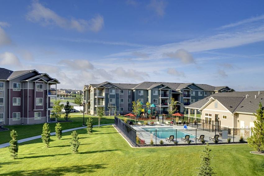 Copper Creek Apartments | Community Portrait Pool with Apt building in background Colorado Springs, CO 80916 Rentals | Copper Creek Apartments