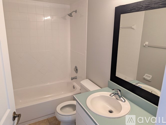 A bathroom with a toilet, sink, and bathtub.