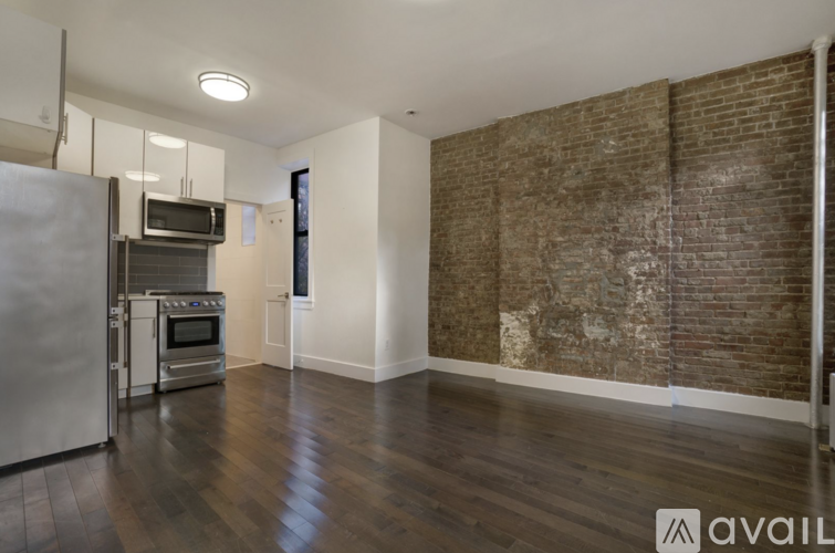 A kitchen with a refrigerator, oven, and microwave.