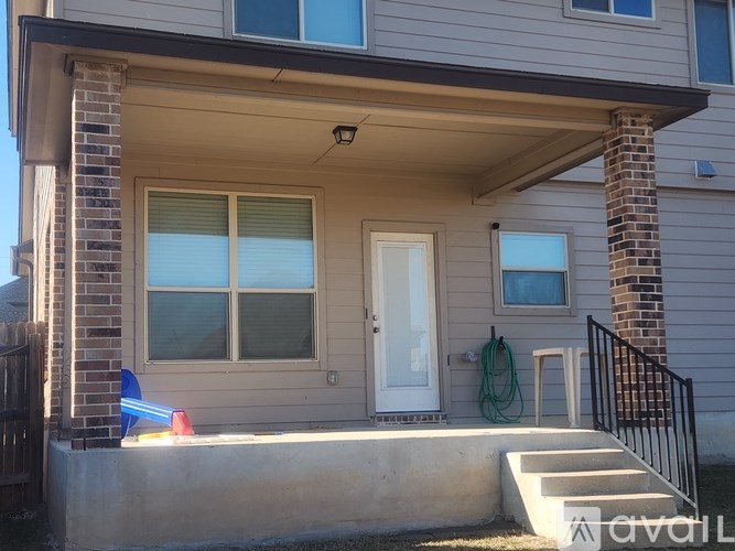 A house with a white door and a small porch.