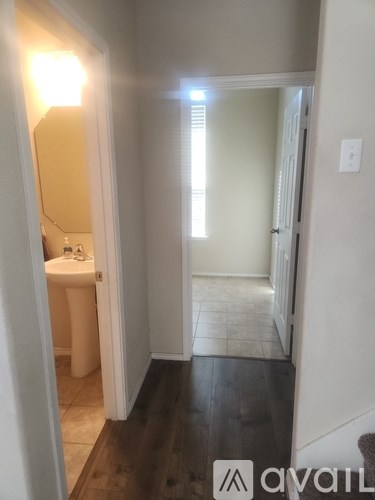 A bathroom with a toilet, sink, and mirror.