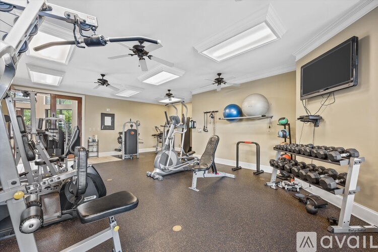 A well-equipped gym with various exercise machines and weights.
