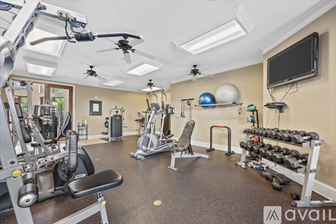 A well-equipped gym with various exercise machines and weights.