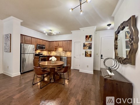 A kitchen with a table and chairs in the middle of the room.