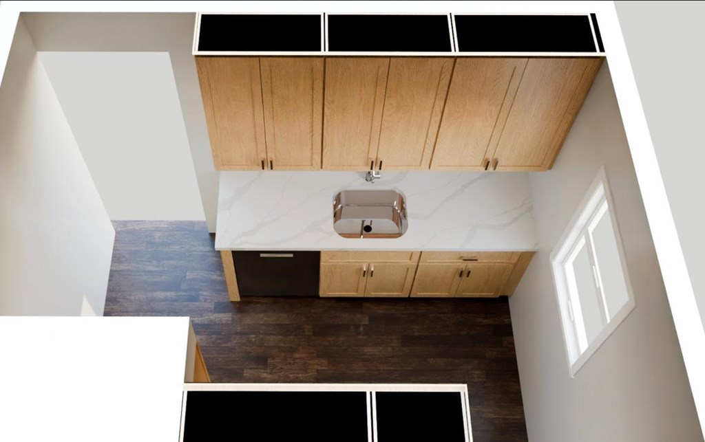 A kitchen with wooden cabinets and a marble countertop.