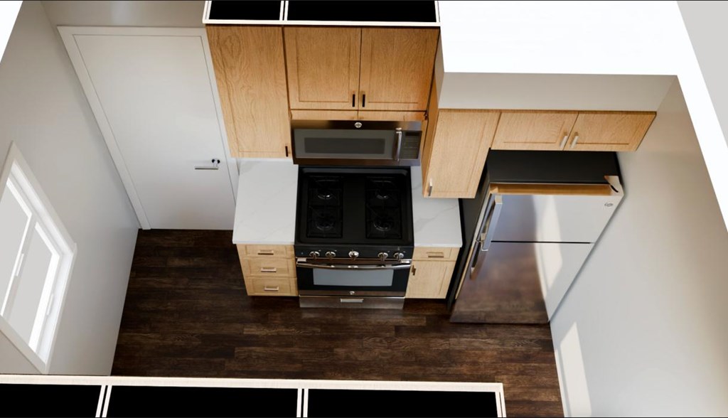 A modern kitchen with wooden cabinets and a black oven.