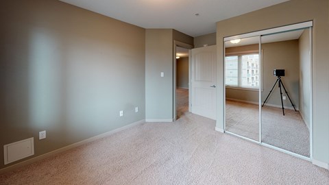 A room with a carpet floor and a white door.