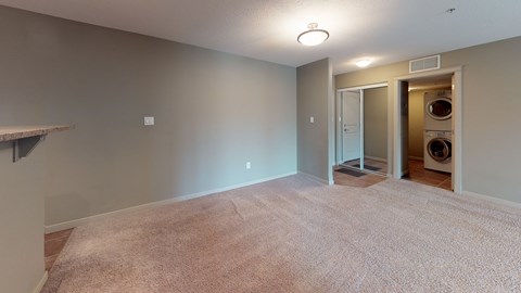 A laundry room with a washer and dryer in a residential setting.