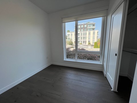 A room with a large window overlooking a building.