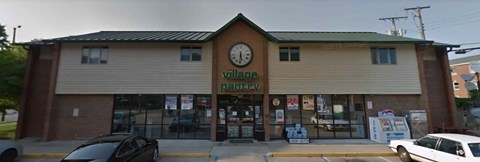 A building with a clock on the front and the words "village" and "perry" written on it.