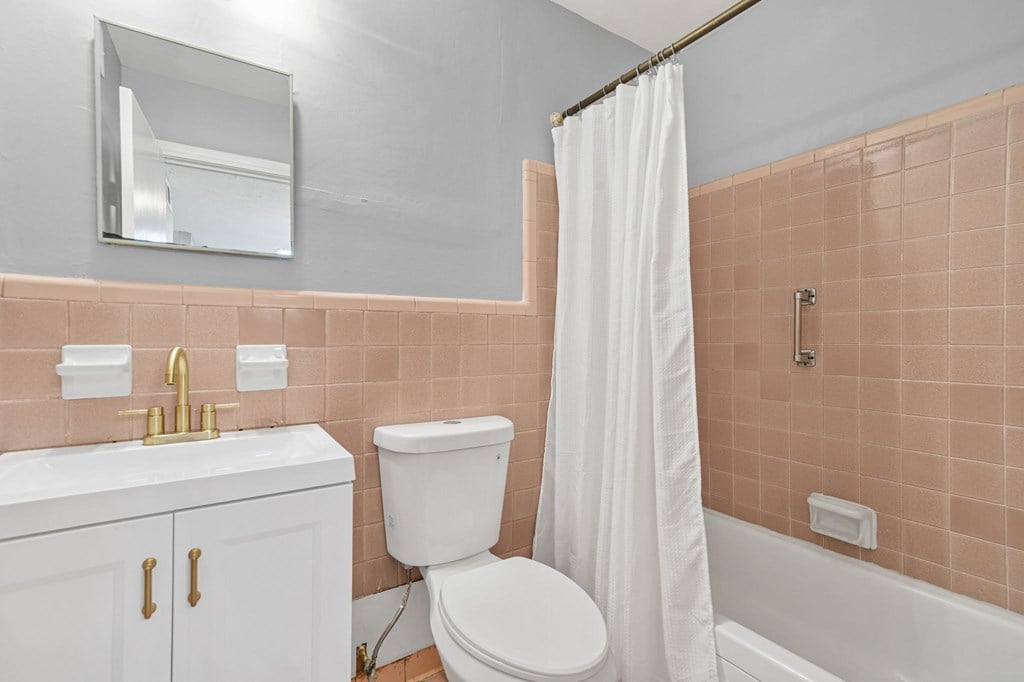 A white toilet sits next to a sink in a bathroom.