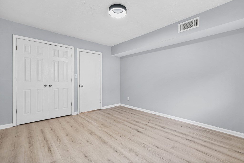 A room with two doors and a ceiling light.