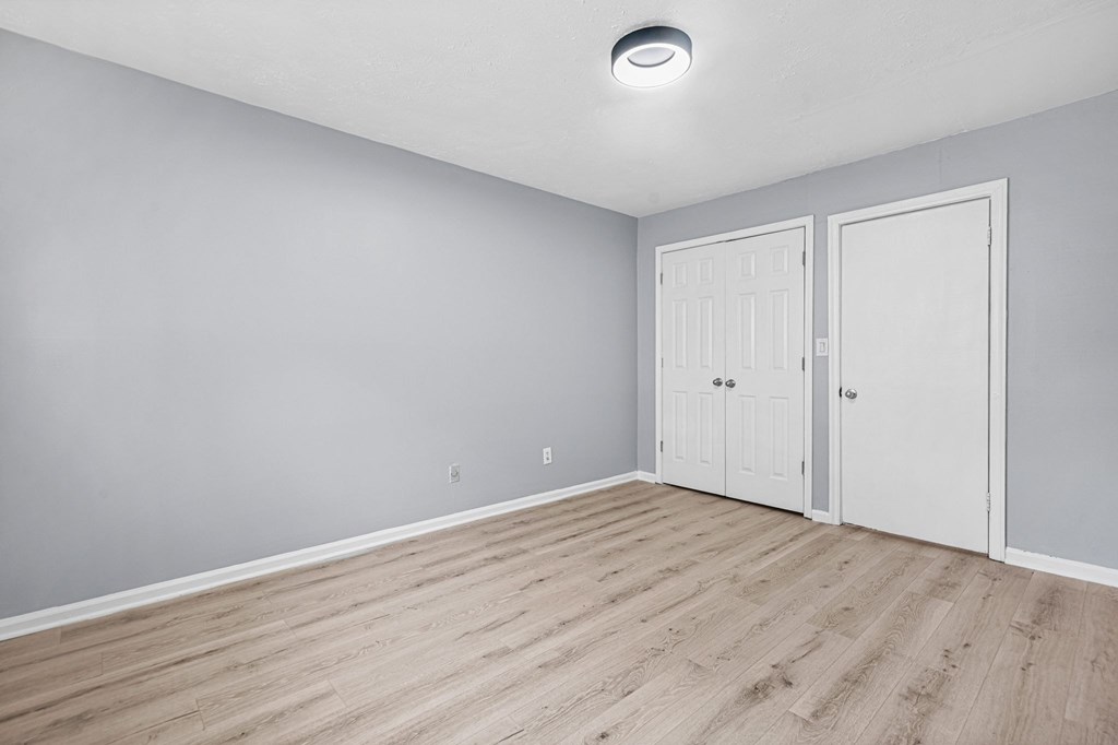 A room with two doors and a ceiling light.