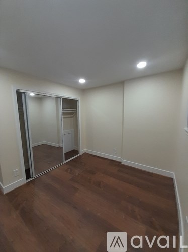 A room with wooden floors and a sliding glass door.