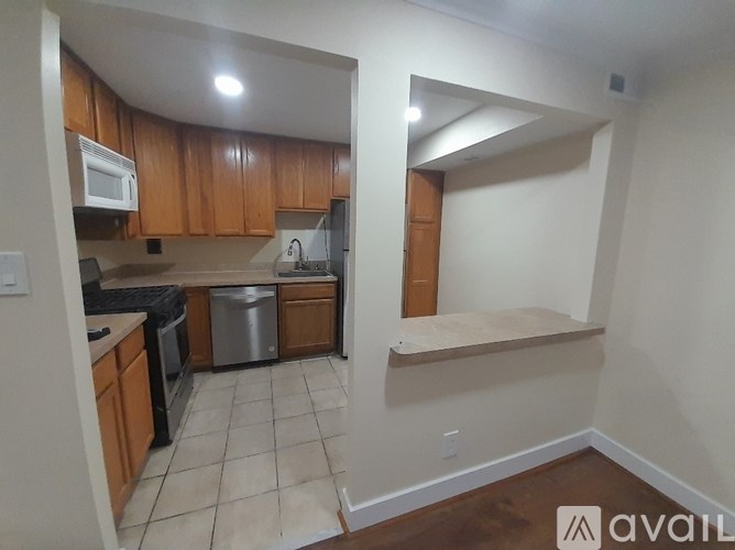 A kitchen with wooden cabinets and a white fridge.