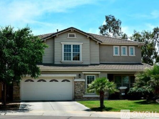 A house with a white garage door and a brown roof.
