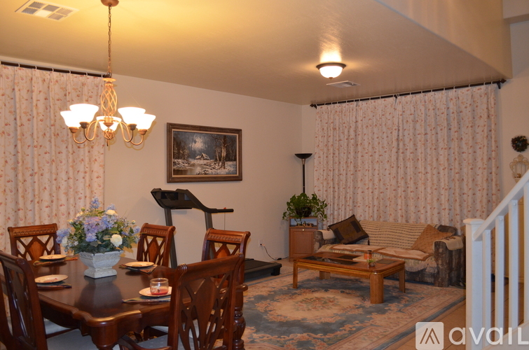 A dining room with a wooden table and chairs.