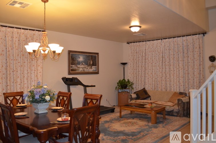A dining room with a wooden table and chairs.
