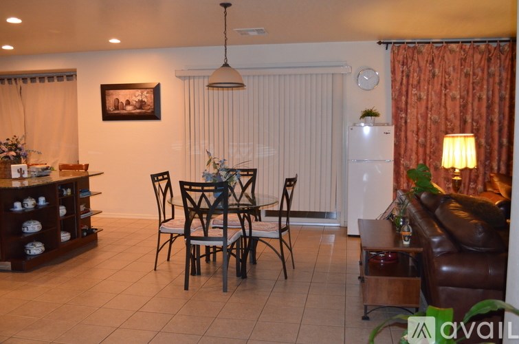 A living room with a dining table and chairs.
