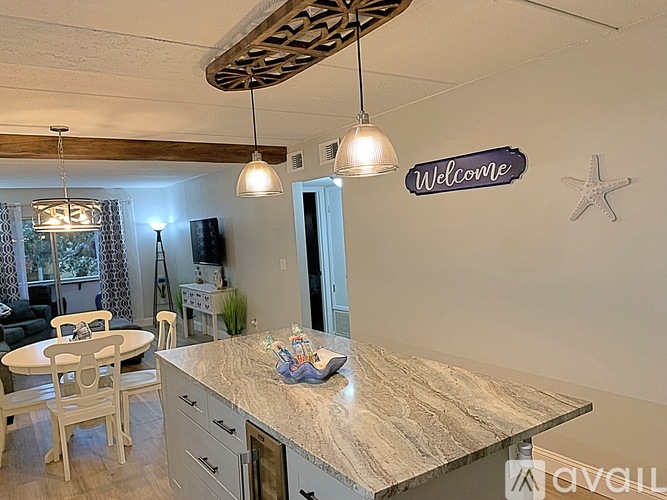 A kitchen with a wooden counter and a sign that says "Welcome".