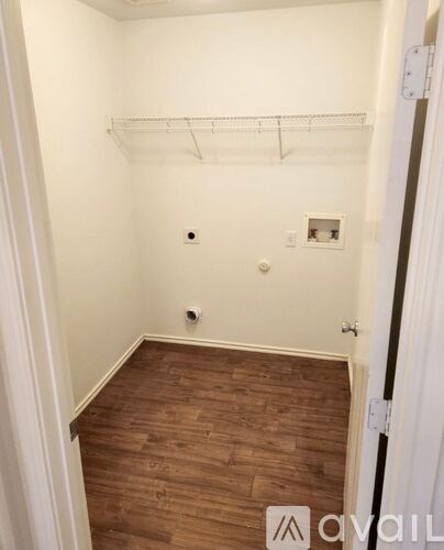 A room with a wooden floor and white walls.