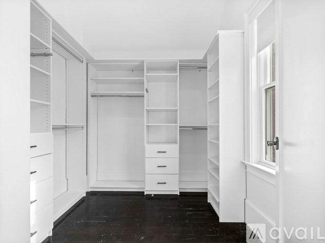 A white closet with drawers and shelves.