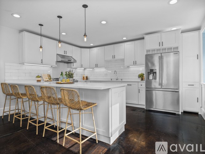 A modern kitchen with white cabinets and a central island.