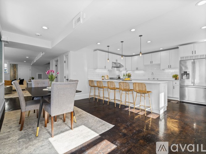 A modern kitchen with a dining table and chairs.