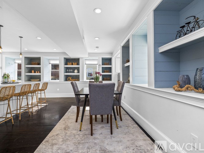 A dining room with a table set for six.