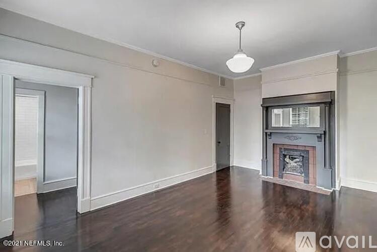 A room with a fireplace and a window.