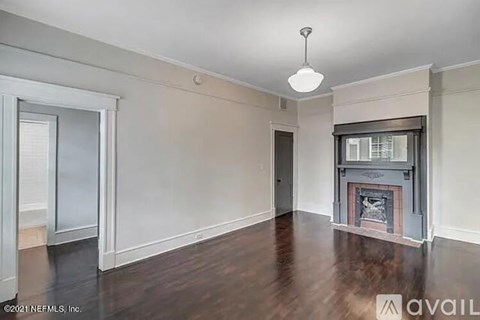 A room with a fireplace and a window.