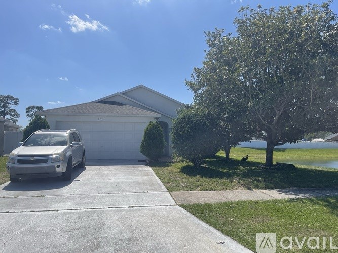 A white SUV is parked in front of a house with a driveway.