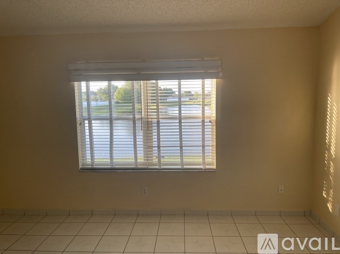 A room with a window and a tiled floor.