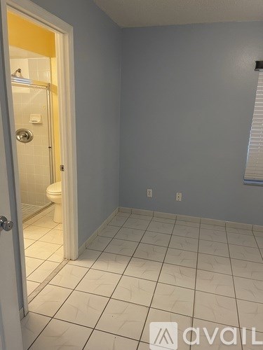 A bathroom with a toilet and a door.